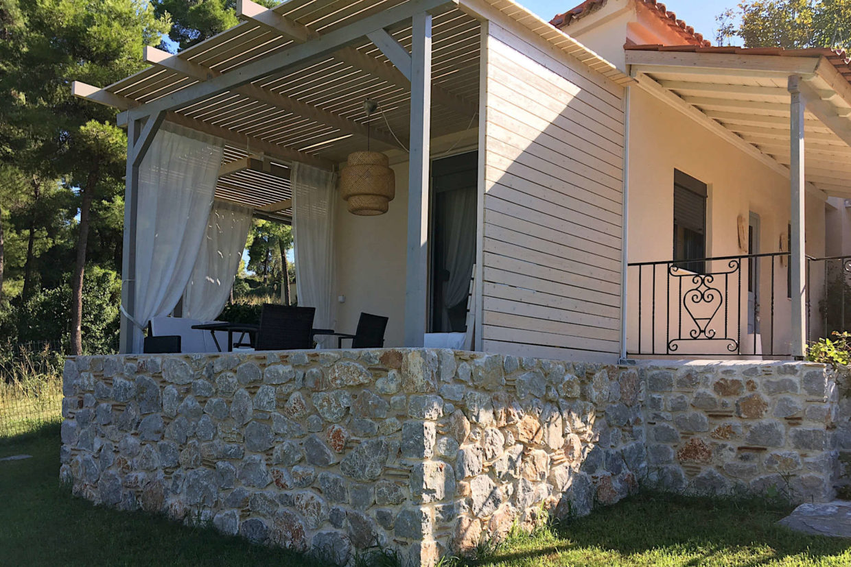 The ideal Greek island bungalow overlooking the garden lawn, pine trees and a superb, unobstructed view of the Aegean Sea, it is all you could ask for.